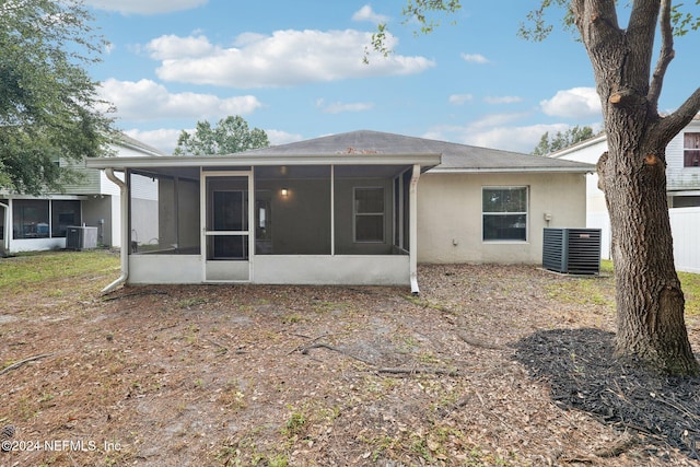 rear view of property with a sunroom and cooling unit