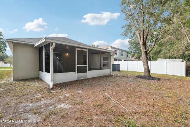 back of property featuring central air condition unit and a sunroom