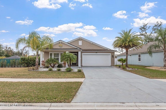 view of front of property featuring a front yard and a garage