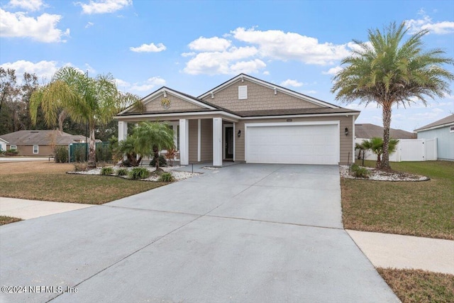 view of front of house featuring a garage and a front yard