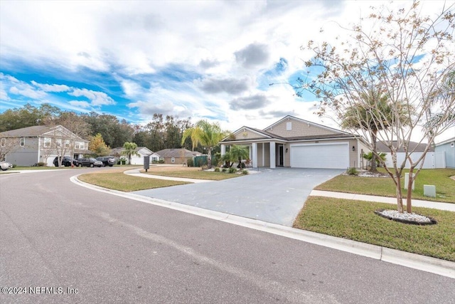 view of front of house featuring a garage and a front lawn