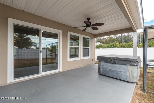 view of patio / terrace with ceiling fan and a hot tub