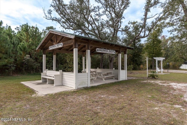 view of property's community with a gazebo, a yard, and a patio area