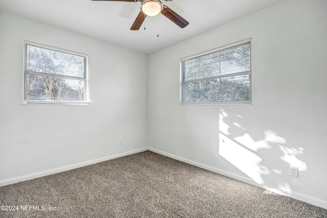 empty room with carpet flooring and ceiling fan