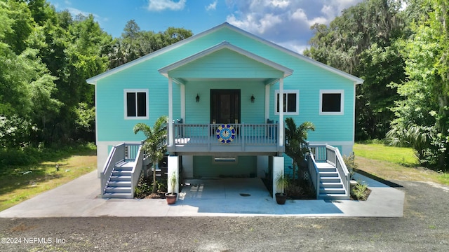 coastal home with a porch and a carport