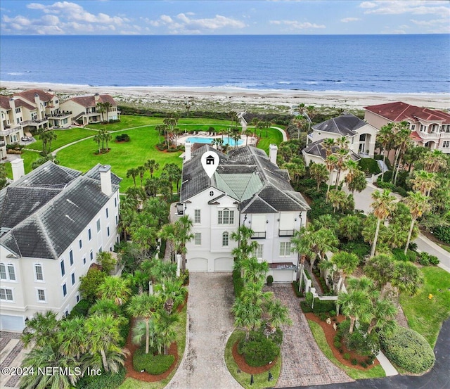 drone / aerial view with a water view and a beach view