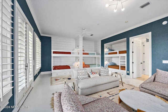 living room with crown molding, a healthy amount of sunlight, and ceiling fan with notable chandelier