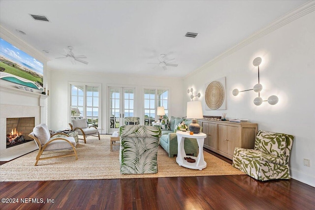 living room featuring ceiling fan, wood-type flooring, crown molding, and french doors