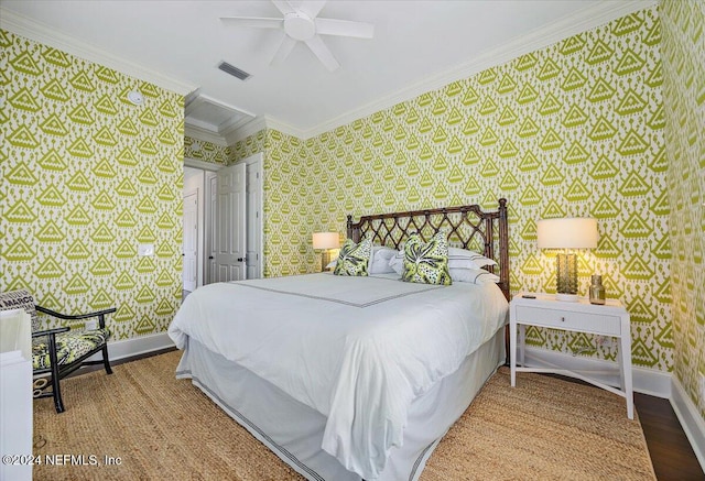 bedroom with hardwood / wood-style flooring, ceiling fan, and ornamental molding