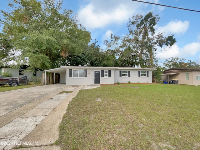 ranch-style home with a carport and a front lawn