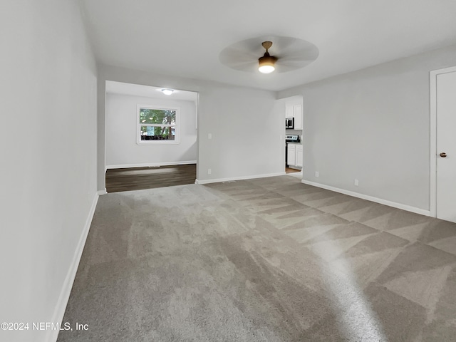 spare room featuring light carpet and ceiling fan