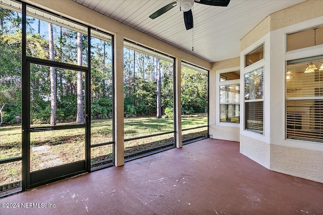 unfurnished sunroom with ceiling fan