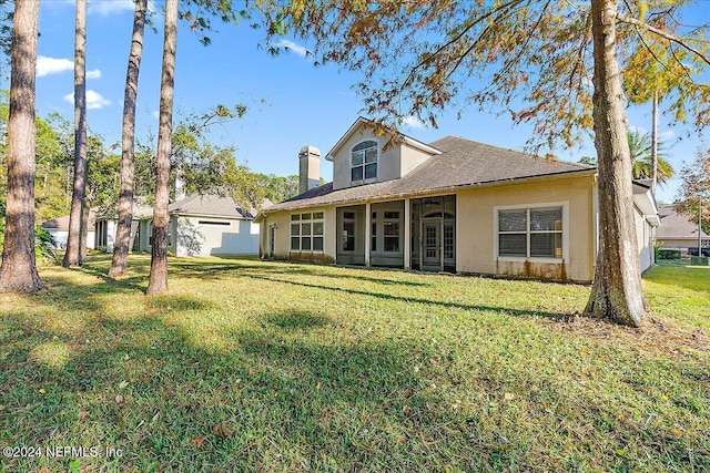 rear view of house with a yard