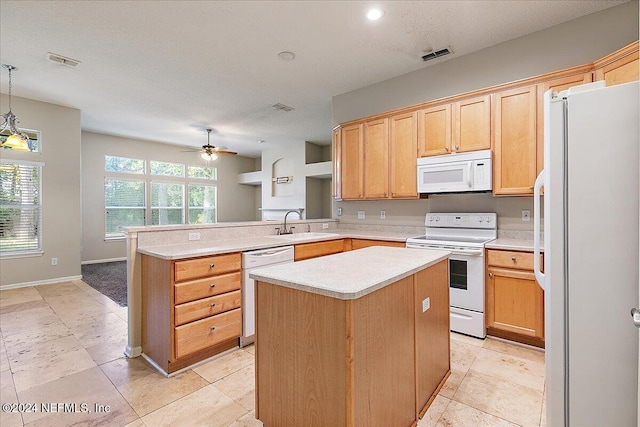 kitchen with kitchen peninsula, white appliances, ceiling fan, pendant lighting, and a kitchen island