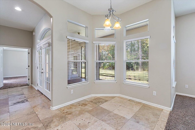 interior space with french doors and a notable chandelier