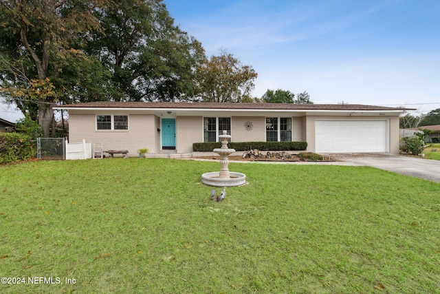 ranch-style house featuring a front lawn and a garage