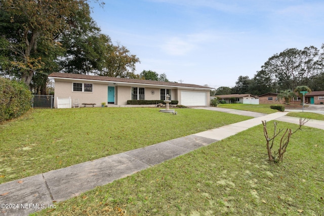 single story home with a garage and a front lawn