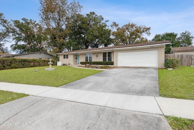 single story home featuring a front yard and a garage