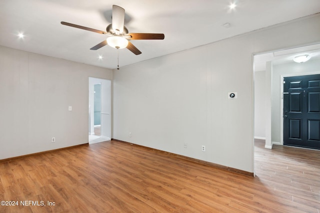 spare room featuring light wood-type flooring and ceiling fan