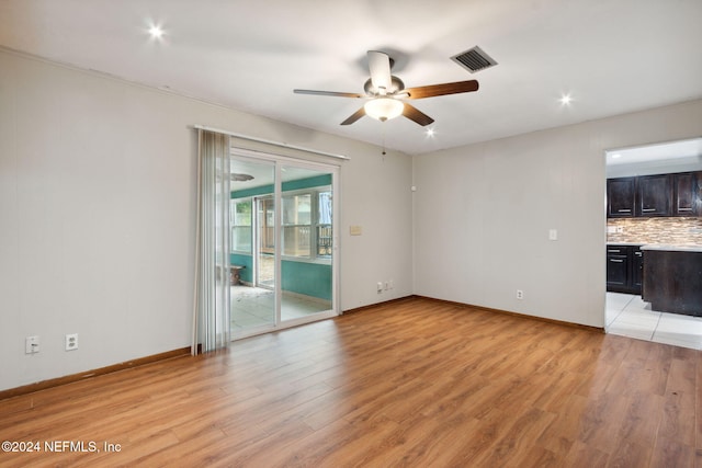 unfurnished living room featuring ceiling fan and light hardwood / wood-style floors