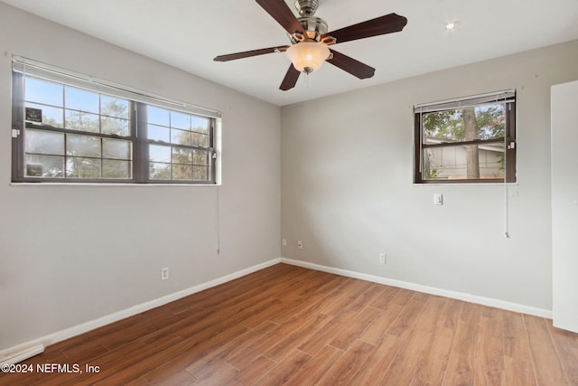 unfurnished room featuring light hardwood / wood-style floors, a wealth of natural light, and ceiling fan