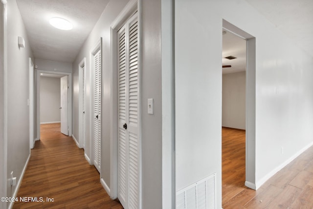 corridor with light wood-type flooring