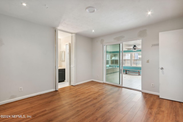 unfurnished room with hardwood / wood-style flooring and ceiling fan