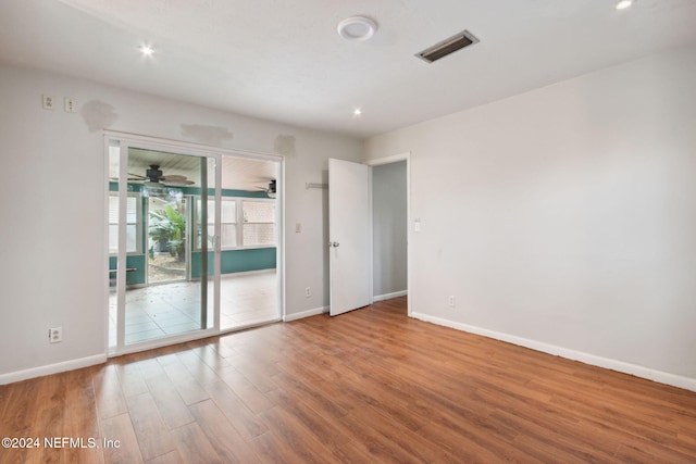 unfurnished room with wood-type flooring