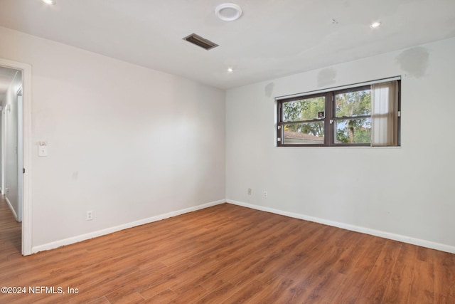 unfurnished room with wood-type flooring