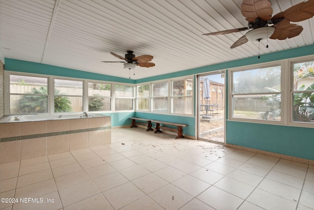 unfurnished sunroom featuring ceiling fan and lofted ceiling