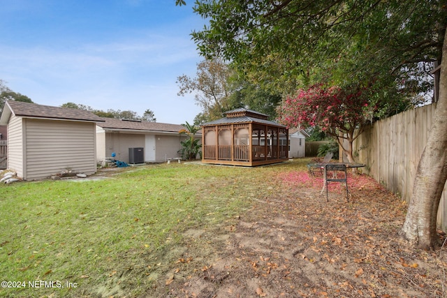 view of yard featuring a gazebo, central AC unit, and a deck