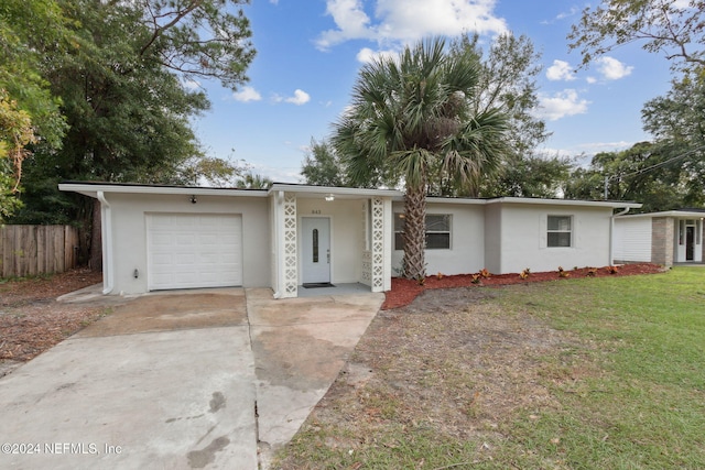 ranch-style house with a front lawn and a garage