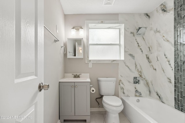 full bathroom featuring toilet, vanity, and tiled shower / bath