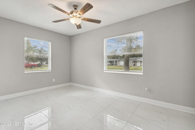 unfurnished room with plenty of natural light and ceiling fan