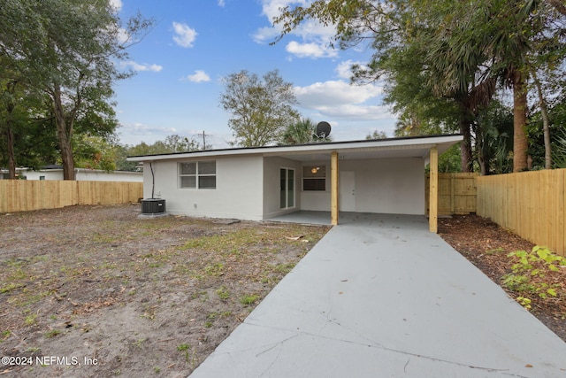 ranch-style house featuring a carport and central air condition unit