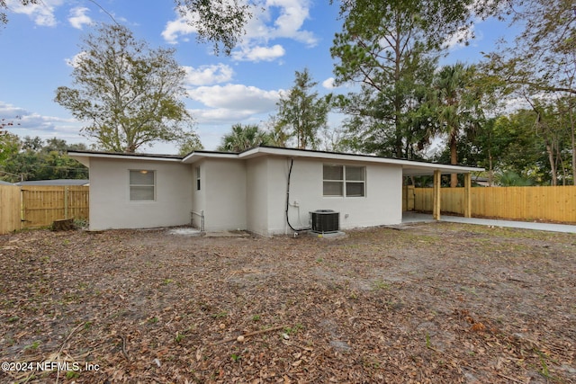 rear view of property featuring central AC