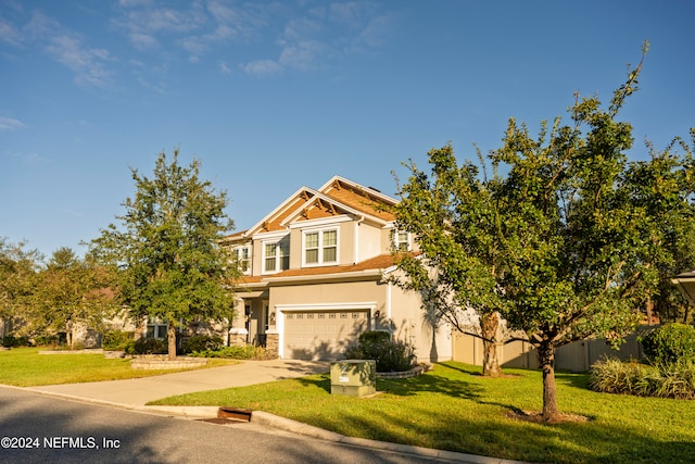 view of front of property featuring a garage and a front lawn