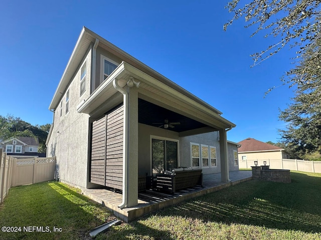 exterior space with a yard and ceiling fan