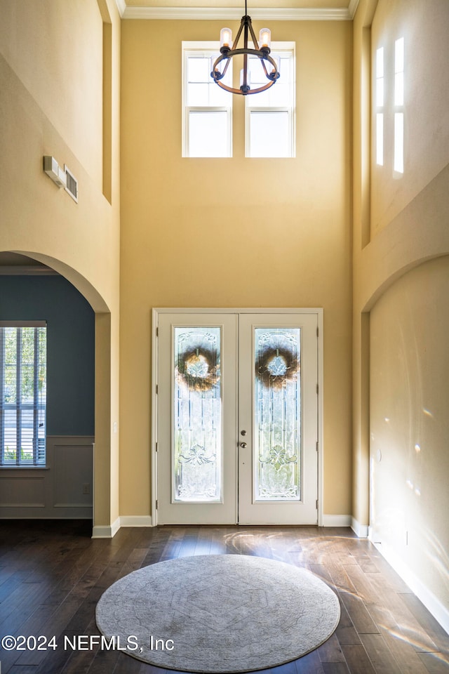 entryway featuring crown molding, dark wood-type flooring, a high ceiling, and french doors