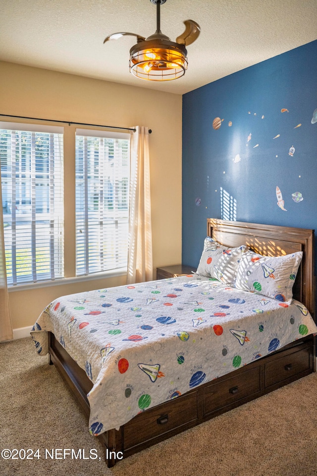 carpeted bedroom with a textured ceiling