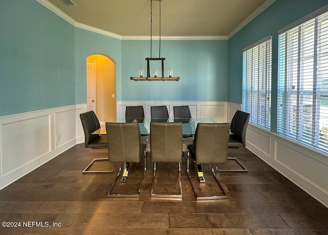 dining space with a healthy amount of sunlight, crown molding, and a chandelier