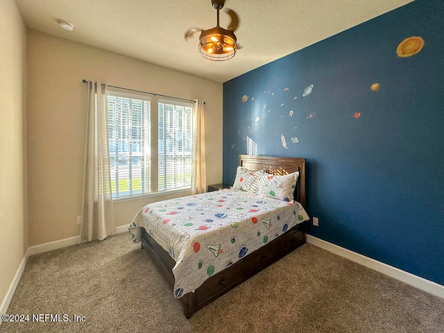 bedroom with carpet and a textured ceiling