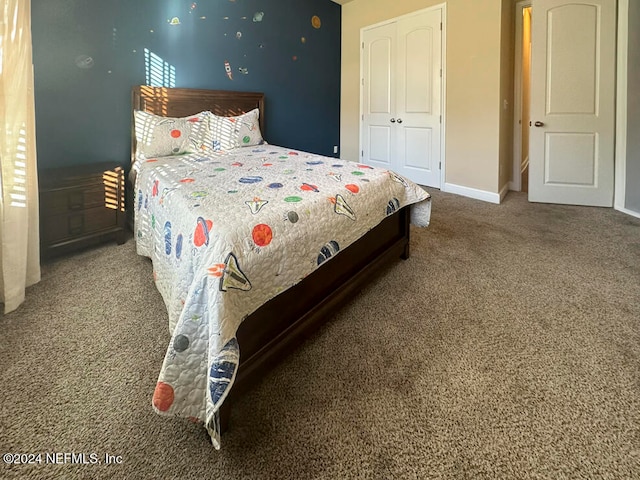 bedroom with carpet flooring and a closet