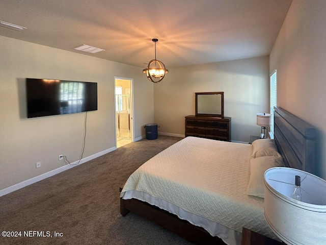 bedroom with carpet, ensuite bath, and an inviting chandelier