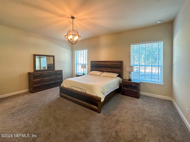 bedroom featuring carpet floors and a notable chandelier