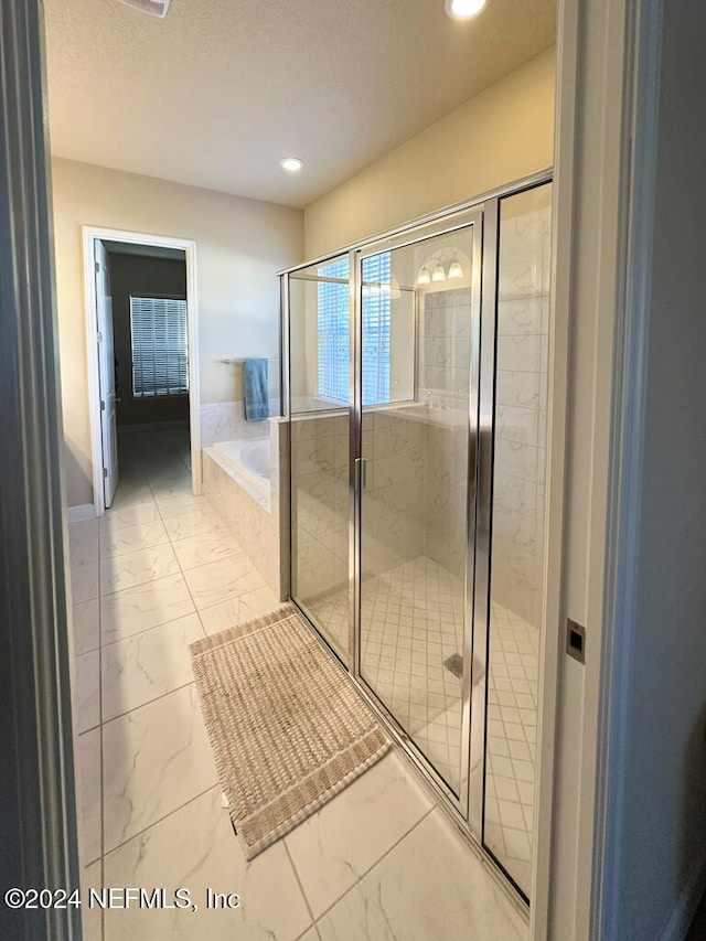 bathroom featuring plus walk in shower