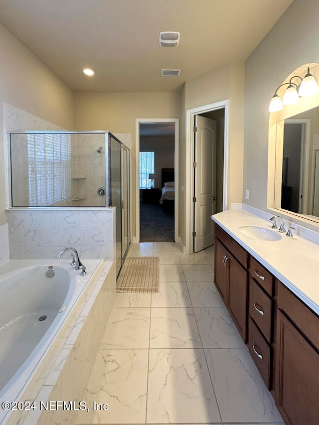 bathroom with vanity and separate shower and tub