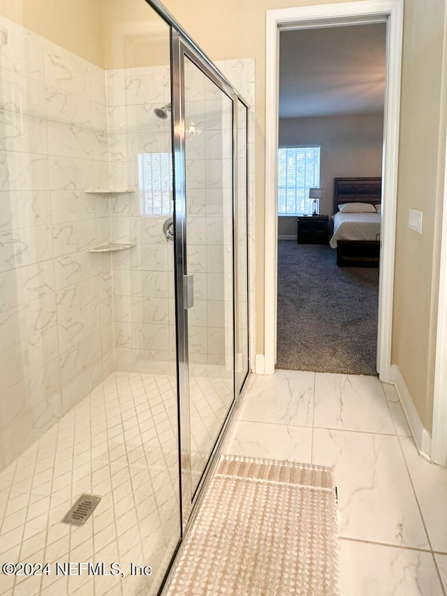 bathroom featuring a shower with shower door