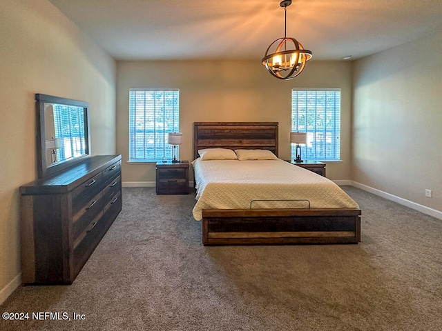 carpeted bedroom featuring a chandelier and multiple windows