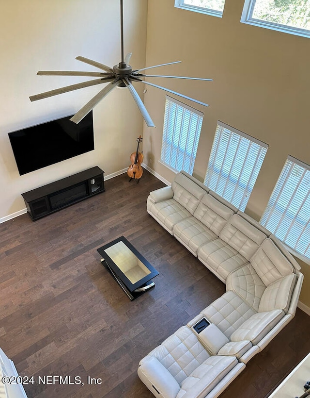 living room featuring ceiling fan and dark hardwood / wood-style flooring